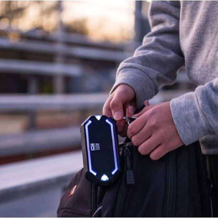 Altec Lansing HydraMini Wireless Bluetooth Speaker held by a man